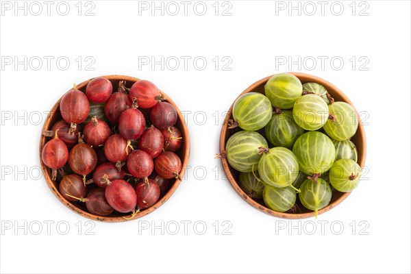 Fresh red and green gooseberry in clay bowl isolated on white background. top view, flat lay, close