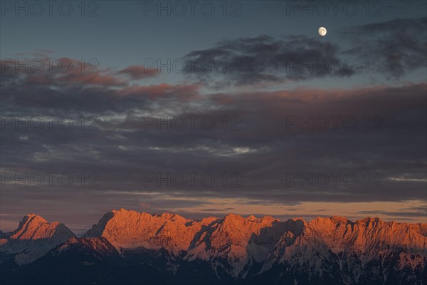 Distant view of steep mountains in the evening light, clouds, autumn, moon, view from Wank to