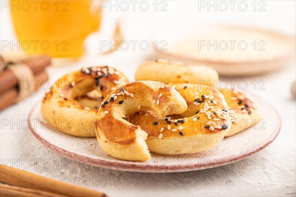 Homemade asian salted cookies, cup of green tea on gray concrete background and linen textile. side
