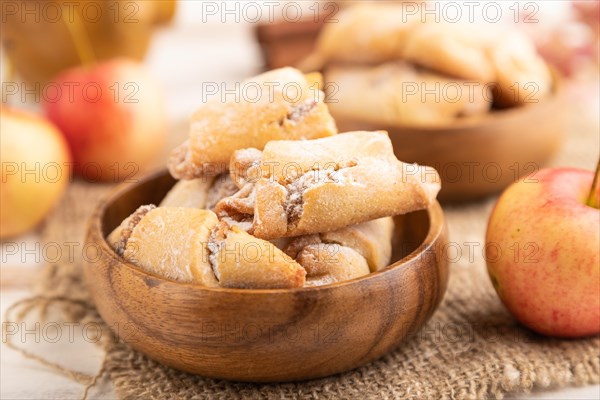 Homemade sweet cookie with apple jam and cup of coffee on white wooden background and linen textile