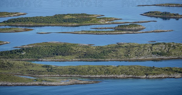 Rocky islands in the blue sea, sea with archipelago islands, Ulvagsundet, Vesteralen, Norway,