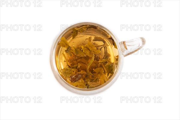 Red tea with herbs in glass cup isolated on white background. Healthy drink concept. Top view, flat