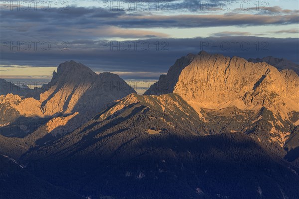Distant view of steep mountains in the evening light, clouds, autumn, view from Wank to Karwendel