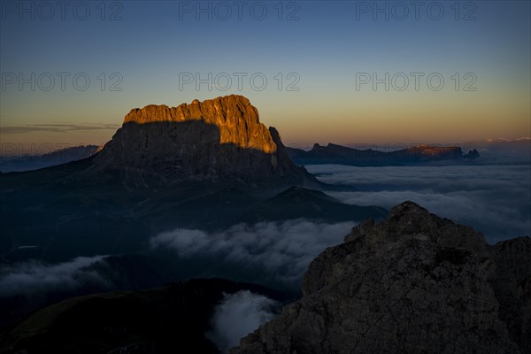 Sunrise over a sea of fog with the peaks of the Sella massif in the background, Corvara, Dolomites,