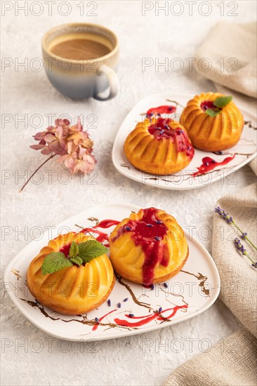 Semolina cheesecake with strawberry jam, lavender, cup of coffee on gray concrete background and