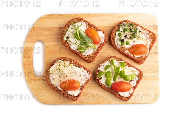 Red beet bread sandwiches with cream cheese, tomatoes and microgreen isolated on white background.