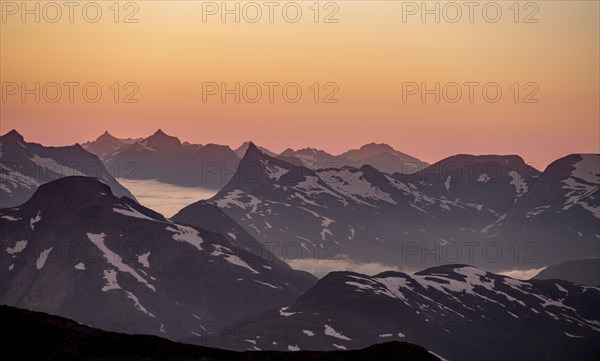 Mountain panorama, mountain peaks in soft light at sunset, view from the summit of Skala, Loen,