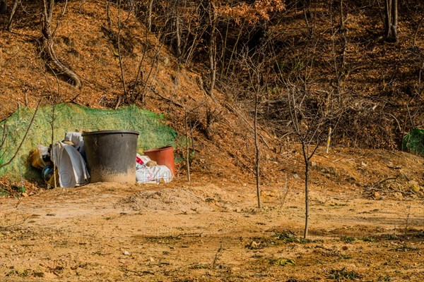 Daejeon, South Korea, January 24, 2020: Two large brown plastic tubs next to bags of fertilizer in