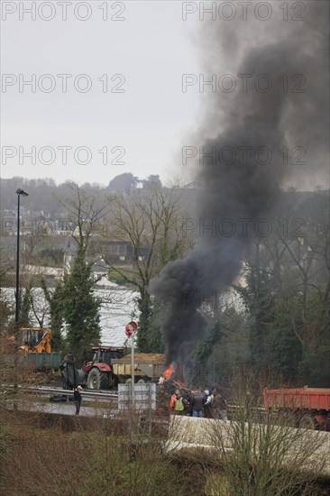 Farmers with tractors, craftsmen with vans and lorry drivers block the closed bridge Pont de