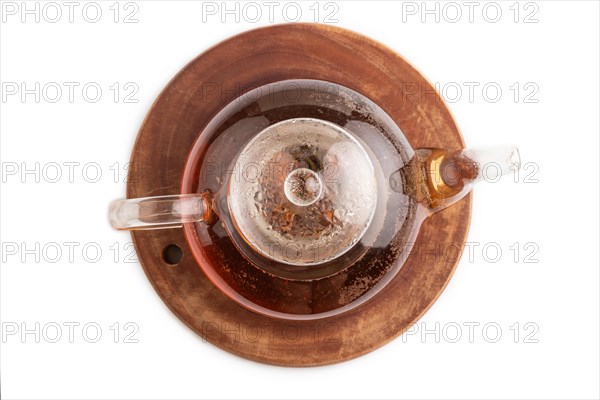 Red tea with herbs in glass teapot isolated on white background. Healthy drink concept. Top view,