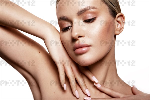 Beauty portrait of model with natural make-up. Fashion shiny highlighter on skin, sexy gloss lips