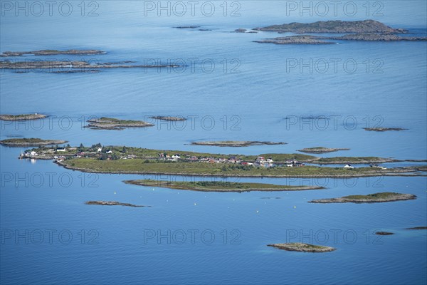 Rocky islands with colourful houses, sea with archipelago islands, Ulvagsundet, Vesteralen, Norway,