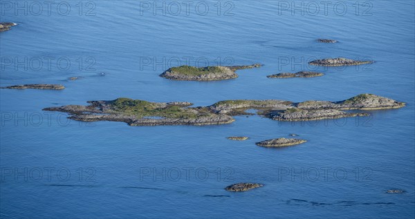 Rocky islands in the blue sea, sea with archipelago islands, Ulvagsundet, Vesteralen, Norway,