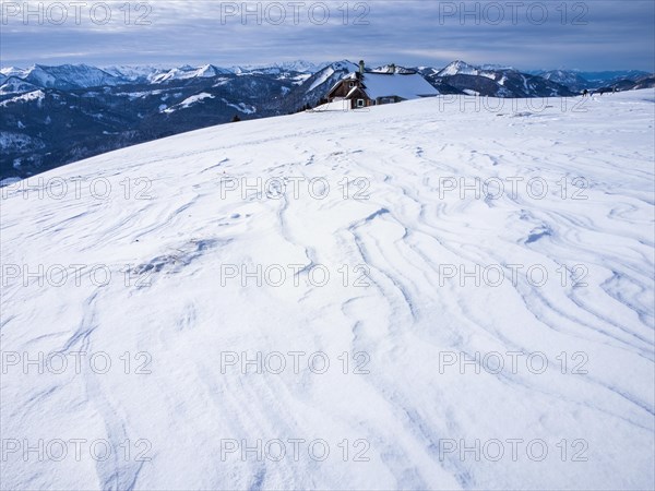 Winter atmosphere, snow-covered landscape, snow-covered alpine peaks, alpine hut on the