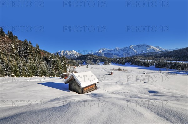 View of the frozen and snow-covered Geroldsee lake in Werdenfelser Land near Garmisch, with the