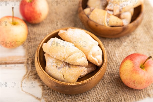 Homemade sweet cookie with apple jam and cup of coffee on white wooden background and linen textile