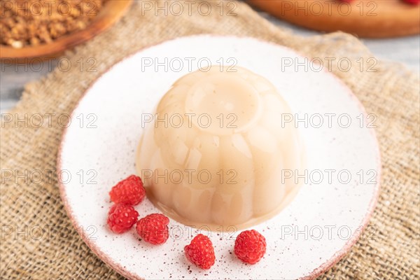 Buckwheat milk jelly on gray wooden background and linen textile. side view, close up, selective
