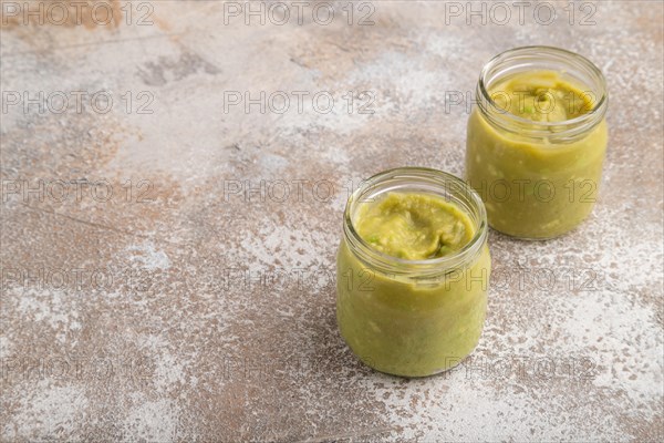 Baby puree with vegetable mix, broccoli, tomatoes, cucumber, avocado infant formula in glass jar on