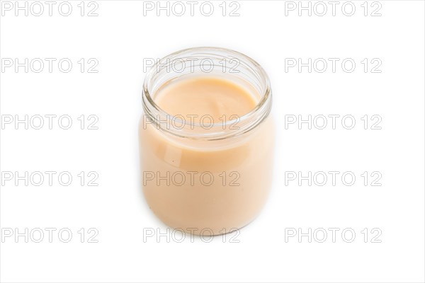 Baby puree with fruits mix, apple, banana infant formula in glass jar isolated on white background.