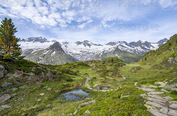 Hiking trail in picturesque mountain landscape, mountain peaks with snow and glacier Hornkees and