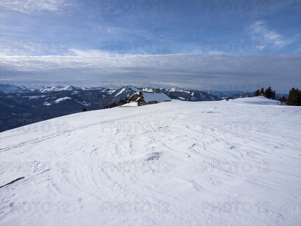 Winter atmosphere, snow-covered landscape, snow-covered alpine peaks, alpine hut on the