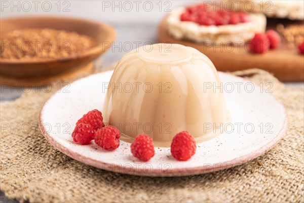 Buckwheat milk jelly on gray wooden background and linen textile. side view, close up, selective