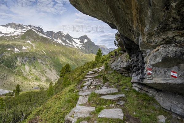 Hiking trail under a rocky outcrop in a picturesque mountain landscape, Berliner Hoehenweg,