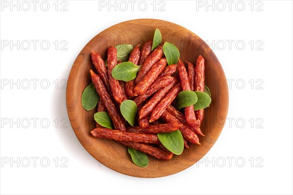 Small smoked sausage with borage microgreen isolated on white background. Top view, flat lay, close
