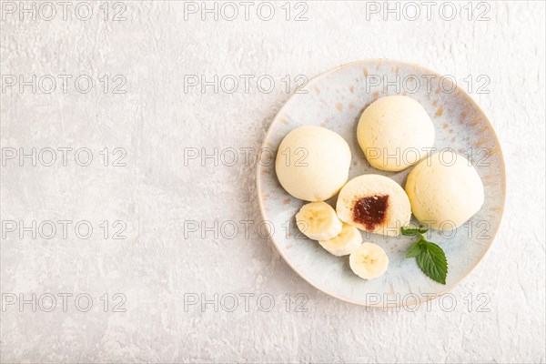 Japanese rice sweet buns mochi filled with jam on a gray concrete background. top view, flat lay,
