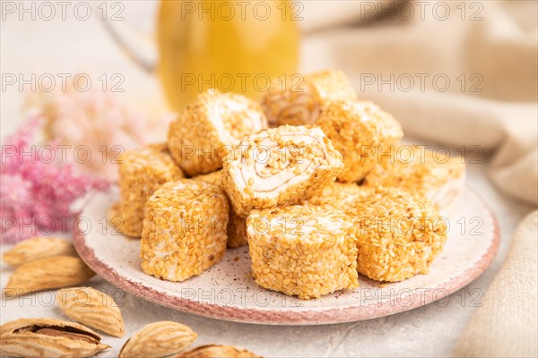 Traditional turkish delight (rahat lokum) with glass of green tea on a gray concrete background and