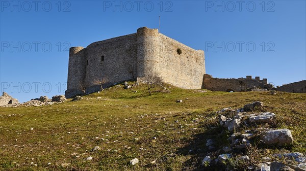 Medieval fortress in a meadow, with a light blue sky in the background, Chlemoutsi, High Medieval