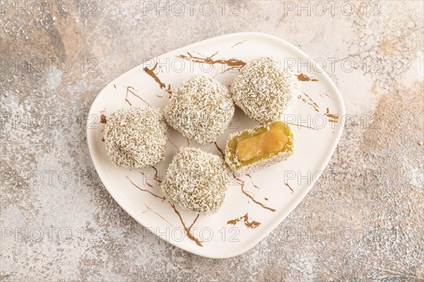 Japanese rice sweet buns mochi filled with pandan jam on brown concrete background. top view, flat