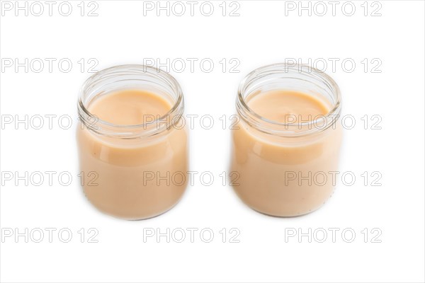 Baby puree with fruits mix, apple, banana infant formula in glass jar isolated on white background.