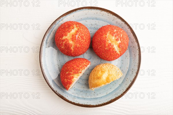 Traditional french custard dessert shu cake on white wooden background. top view, flat lay, close