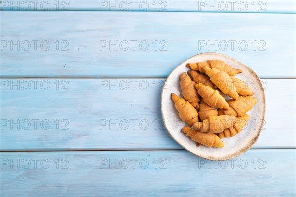 Homemade bagel roll on a blue wooden background. top view, flat lay, copy space