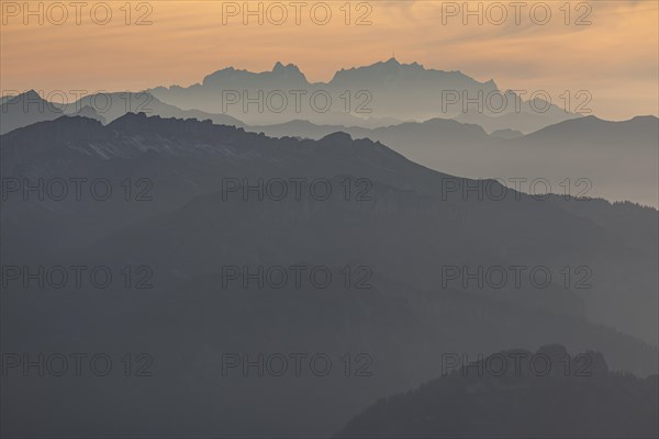 Silhouette of a mountain peak in the evening light, haze, backlight, autumn, view from the
