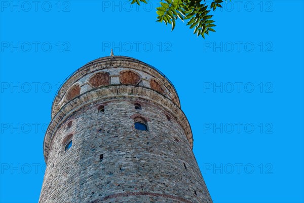 Low angle view of Galata tower in Istanbul against blue sky in Istanbul, Tuerkiye