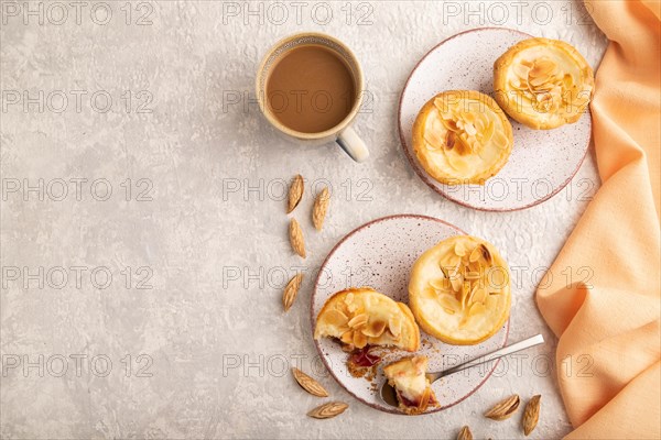 Traditional portuguese cakes pasteis de nata, custard small pies with almonds with cup of coffee on