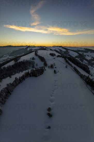 Sunset over the second Jura chain in winter, foreground contours of sinkholes, view towards the