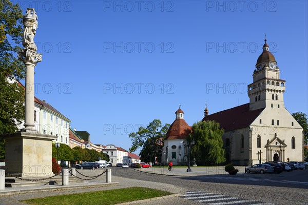 Town square with a statue in the foreground, church in the background on a sunny day, Roman