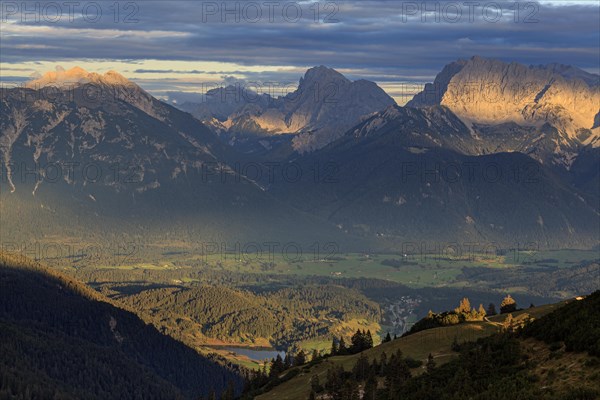 Distant view of steep mountains in the evening light, clouds, autumn, view from Wank to Karwendel