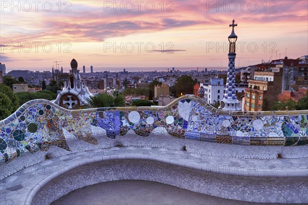 Curved bench, ceramic mosaic, Trencadis, viewing platform at sunrise, Park Güell, Barcelona, Spain,