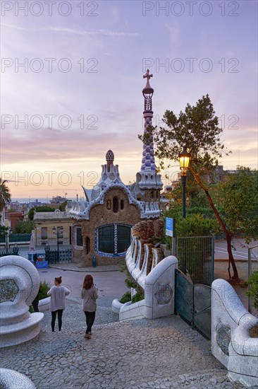 View from the dragon staircase of buildings with colourful mosaics, Park Güell entrance, dawn,