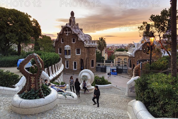View from the dragon staircase of buildings with colourful mosaics, Park Güell entrance, dawn,