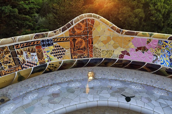 Curved bench, ceramic mosaic, Trencadis, sunrise, Park Güell, Barcelona, SpainTrencadis