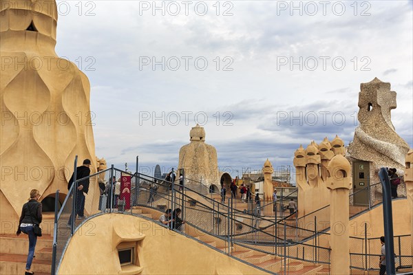 Tourists between artistically designed fireplaces on the large viewing platform, roof terrace in