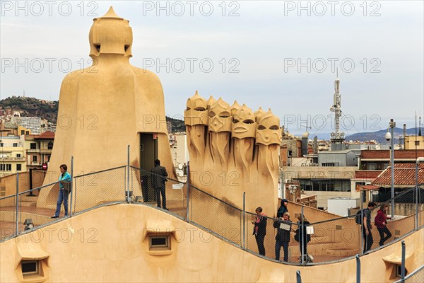 Tourists between artistically designed fireplaces on the large viewing platform, roof terrace in
