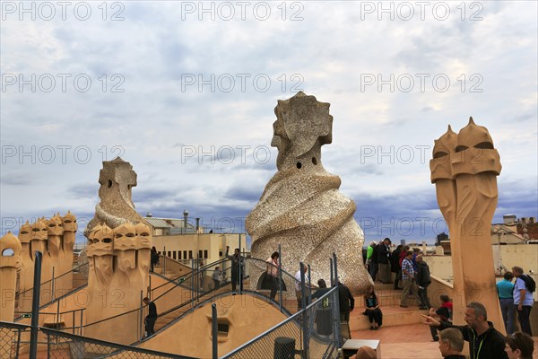 Tourists between artistically designed fireplaces on the large viewing platform, roof terrace in