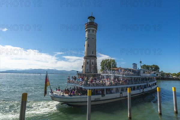 Lindau at Lake Constance, entrance to the seaport, passenger ship with many holidaymakers, crowd,