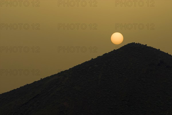 The sun on Tenerife on a volcanic hill, obscured by sahara dust, calima, Canary Islands, Spain,